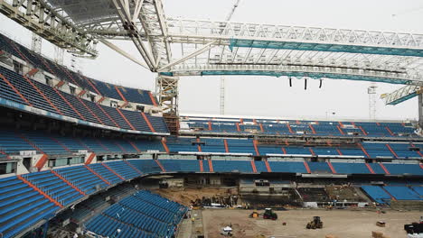 Heavy-Equipment-At-Work-In-An-Open-Football-Stadium-Under-Construction-In-Madrid,-Spain
