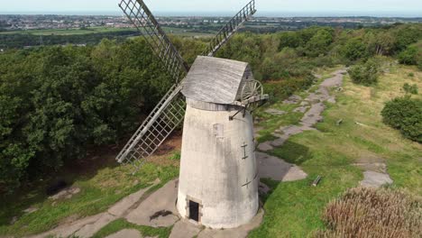 Bidston-hill-disused-rural-flour-mill-restored-traditional-wooden-sail-windmill-Birkenhead-aerial-view-close-orbit-left