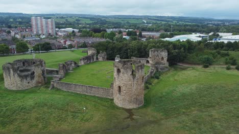 Flint-castle-Welsh-medieval-coastal-military-fortress-ruin-aerial-view-push-in-to-tower