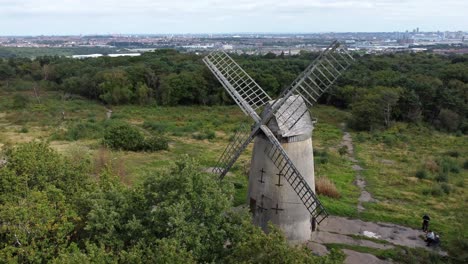 Bidston-hill-disused-rural-flour-mill-restored-traditional-wooden-sail-windmill-Birkenhead-aerial-view-rising-left-over-trees