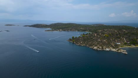 4K-Drone-clip-slowly-rotating-over-a-tropical-island-in-the-bay-of-Vourvourou,-in-Chalkidiki,-northern-Greece