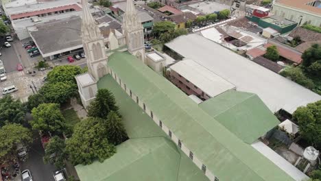 Old-Cathedral-Of-Nuestra-Senora-Del-Carmen-In-El-Salvador-And-Surrounding-Town--aerial-shot
