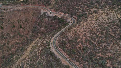 4K-aerial-following-car-up-curvy-mountain-road-in-Prescott-National-Forest-AZ
