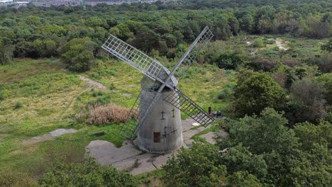 Bidston-hill-disused-rural-flour-mill-restored-traditional-wooden-sail-windmill-Birkenhead-aerial-view-dolly-left
