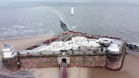 Fort-Perch-Rock-New-Brighton-sandstone-coastal-defence-battery-museum-aerial-view-fly-over-tilt-down