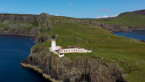 Rotating-drone-shot-of-Neist-Point-lighthouse-and-rocky-shoreline-cliffs-in-Scotland