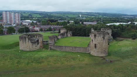 Flint-castle-Welsh-medieval-coastal-military-fortress-ruin-aerial-view-wide-right-rotating-orbit