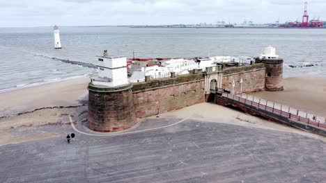 Fort-Perch-Rock-New-Brighton-sandstone-coastal-defence-battery-museum-and-lighthouse-aerial-view-low-orbit-right