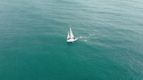 Aerial-shot-of-a-drone-flying-around-a-sailing-boat-on-the-English-ocean