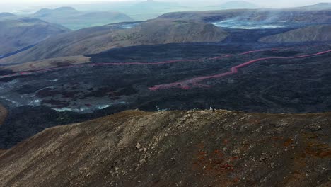 People-Visiting-Active-Volcano,-Mount-Fagradalsfjall,-Iceland---aerial-drone-shot