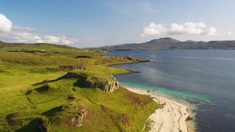 Wide-rotating-drone-shot-of-Coral-Beach-in-Claigan-with-white-sandy-beaches-and-tropical-blue-water,-in-Scotland