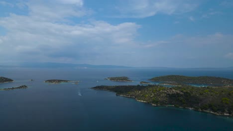 Rotating-drone-clip-over-a-beatiful-formation-of-islands-in-the-bay-of-Vourvourou,-Halkidiki,-Northern-Greece