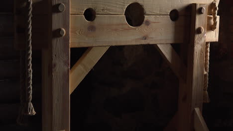 A-Pillory-is-made-of-a-wooden-framework-with-holes-for-the-head-and-hands,-located-in-a-fortress
