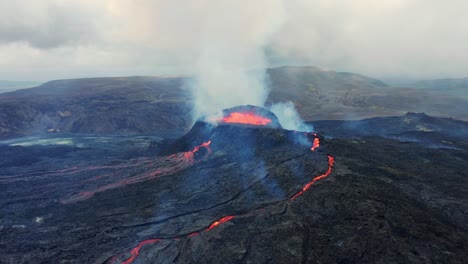 Hot-lava-and-magma-coming-out-of-the-crater,-volcano-Fagradalsfjall-located-in-the-valley-Geldingadalir,-Iceland---aerial-shot