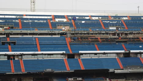 Concrete-Bucket-Lift-By-Tower-Crane-Lowered-To-The-Construction-Site-Of-Santiago-Bernabeu-Stadium-In-Madrid,-Spain