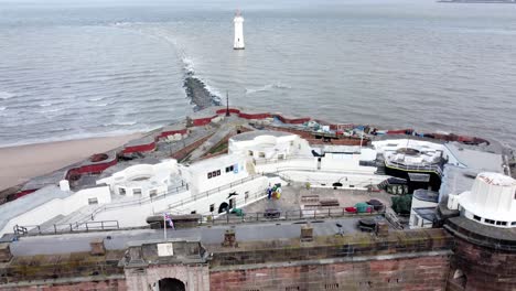 Fort-Perch-rock-New-Brighton-sandstone-coastal-defence-battery-museum-birdseye-aerial-view-pull-back-tilt-up-reveal