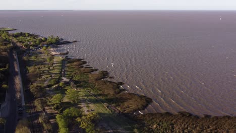 Aerial-drone-shot-of-river-shore-of-River-Plate-during-windy-day---Rural-Coastline-in-San-Isidro,-Buenos-Aires