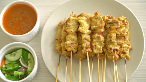 Pork-satay-with-peanut-sauce-pickles-which-are-cucumber-slices-and-onions-in-vinegar---Asian-food-style