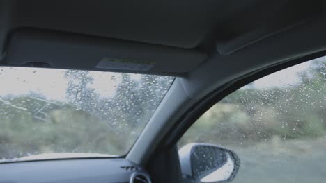 Ein-Männlicher-Fahrer-Fährt-Und-Biegt-Im-Regen-Auf-Einer-Unbefestigten-Straße-Links-Ab