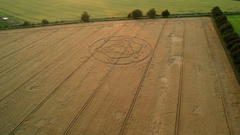 Wiltshire-wheat-field-countryside-crop-circle-molecular-pattern-aerial-view-rural-scene-orbit-left-n-at-sunset