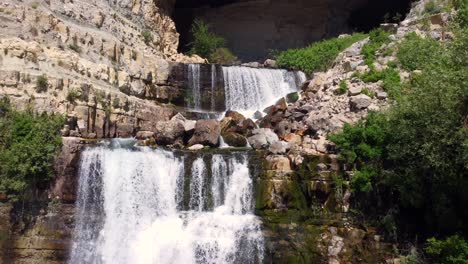 Shallow-Waterfall-Cascading-From-Afqa-In-Lebanon---tilt-up-shot