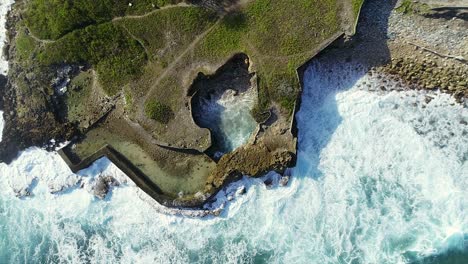 Aerial-top-down-view-of-waves-breaking-on-Najayo-beach-in-Dominican-Republic