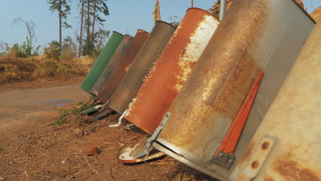 A-line-of-mail-boxes-that-were-abandoned-after-wildfire-in-Paradise,-CA