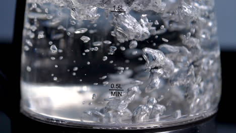Rapid-boiling-water-in-a-clear-glass-kettle,-slow-motion,-close-up