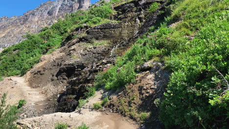 Closed-shot-of-the-stream-flowing-through-the-mountains-surrounding-the-glacial-valley-of-the-Highline-Trail-Logan-Pass