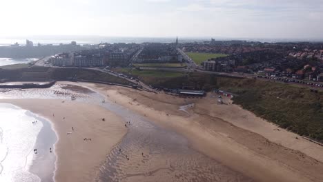 Cinematic-Aerial-Shot-of-Tynemouth-Long-Sands-Beach-on-a-Warm-Summer-Day