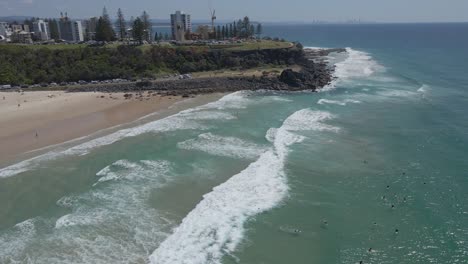 Skyscrapers-Near-The-Point-Danger-Lookout-And-Surfers-At-Duranbah-Beach-In-Gold-Coast,-Australia