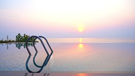 Empty-Outdoor-Infinity-Pool-with-Panoramic-Sea-View,-at-Sunrise