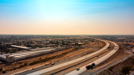 Traffic-on-a-highway-at-sunset-near-Lancaster-in-southern-California---aerial-time-lapse