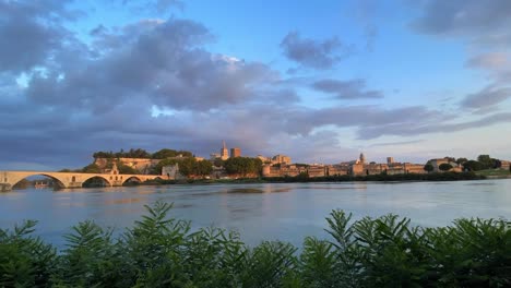 Timelapse-of-Pont-d'Avignon-with-bridge-and-city-skyline-during-sunset-in-Provence,-France