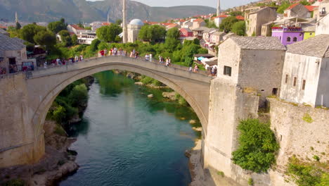 Mostar-Stari-Most---Old-Arched-Bridge-Over-Neretva-River-Popular-For-Tourists-In-Background-In-Mostar,-Bosnia-And-Herzegovina