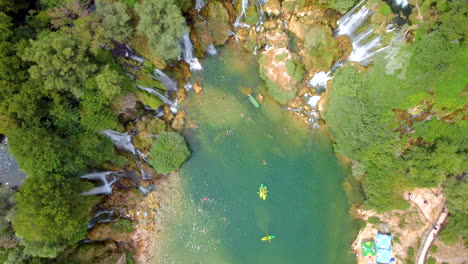 Top-View-Of-Kravica-Waterfall-With-Several-Tourists-On-Holiday-Vacation-Near-Ljubuski-In-Bosnia-and-Herzegovina