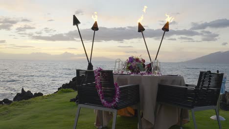 A-romantic-table-set-for-two-at-sunset-on-the-island-of-Maui,-Hawaii