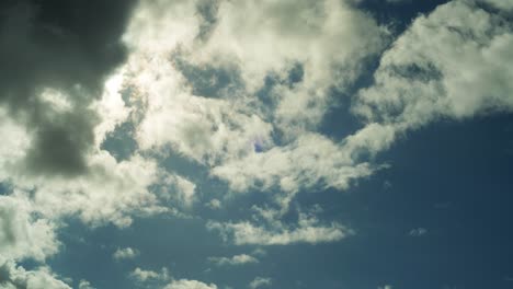 4K-timelapse-of-a-sunny-blue-sky,-with-clouds-passing-by-in-front-of-the-sun