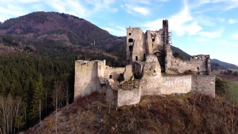 Ruinas-De-Un-Castillo-Medieval-Desde-El-Frente-De-Un-Dron-En-Medio-De-Las-Montañas-De-Un-Paisaje-Eslovaco