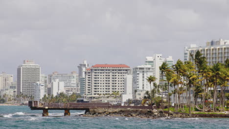 View-across-El-Boqueron-Bay-on-sunny-day-toward-buildings-of-Condado-Beach,-San-Juan,-Puerto-Rico