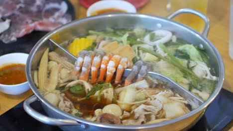 4k-video-POV-while-putting-pork-slice-meat-into-hotpot-shabu-shabu-full-with-vegetable-and-meat