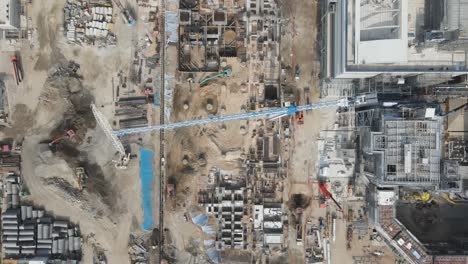 Top-down-aerial-of-industrial-construction-site-with-two-huge-tower-cranes