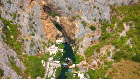 Aerial-View-Of-Dervish-House-And-Vrelo-Bune-On-Buna-River-In-Blagaj,-Bosnia-and-Herzegovina