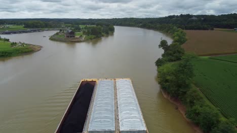 aerial-shot-of-a-barge-towing-coal-and-sand-on-the-cumberland-river-during-a-cloudy-day