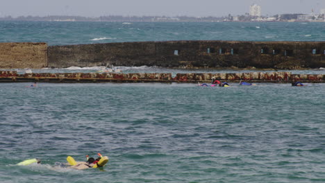 Tourist-snorkeling-in-the-sea-water-surface-at-San-Juan-Puerto-Rico,-USA