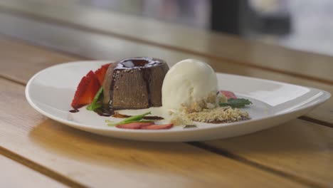 4K-close-up-shot-of-tasty-vanilla-chocolate-dessert-served-on-fancy-plate-in-restaurant
