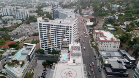Aerial-view-of-traffic-on-the-sunset-blvd-road-in-West-Hollywood---tracking,-drone-shot