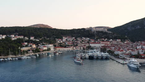 Port-Of-Hvar-With-The-Old-City-In-Croatia-At-Sunrise---aerial-drone-shot