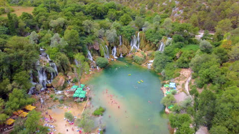 Aerial-View-Of-People-Swims-At-Pristine-Water-Of-River-Coming-From-Kravica-Waterfall