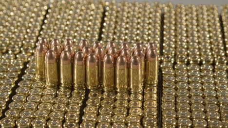 Wide-Dolly-of-9-millimeter-bullets-standing-on-loads-of-new-ammunition